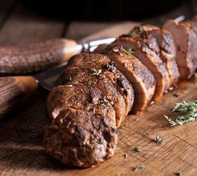 grilled pork tenderloin recipe juicy pork tenderloin, Close up image of a sliced grilled pork tenderloin on a wooden cutting board