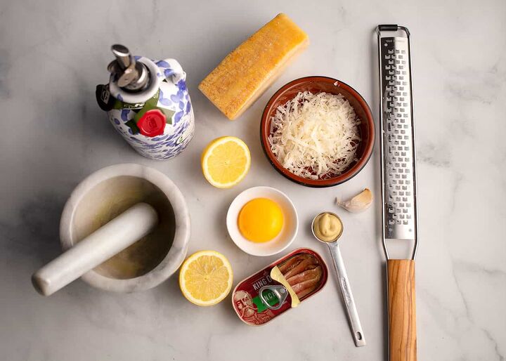 parmesan crusted chicken with caesar salad, All of the ingredients for a Caesar salad dressing freshly grated parmesan cheese lemon mustard egg yolk anchovies garlic olive oil