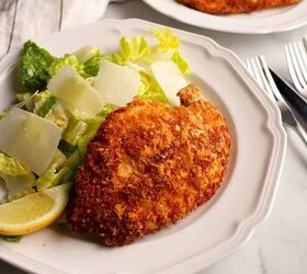 parmesan crusted chicken with caesar salad, Close up of the Parmesan Chicken with the salad and parmesan shavings