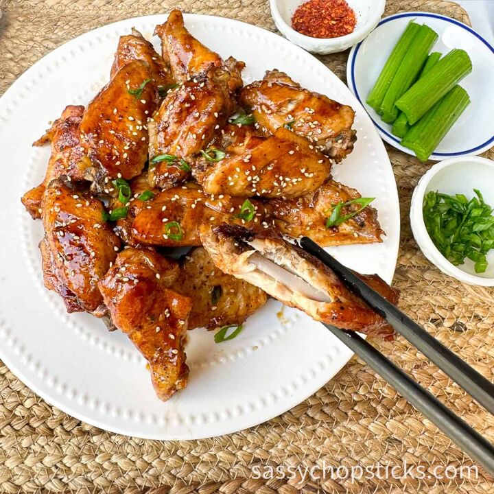 sticky baked asian chicken wings fall off the bone, bitten wing close up