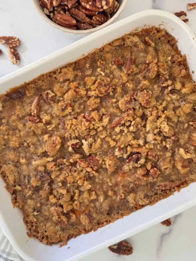 gluten free corn casserole, Gluten free sweet potato casserole in a white dish with pecans scattered around it