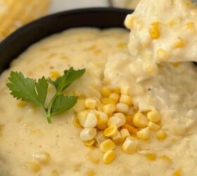 gluten free corn casserole, Gluten free creamed corn in a black bowl with someone spooning some out