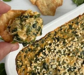 baked feta dip, Quick Spinach And Crab Dip Featured Image Holding a cracker with some dip on it