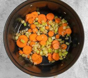 coconut curry soup, Chopped carrots onions and celery being saut ed in a large black pot