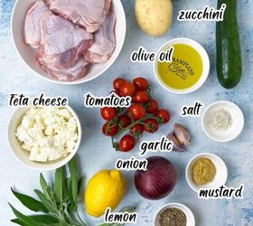 sheet pan chicken thighs and veggies, Ingredients laid out on a blue surface including chicken thighs potatoes zucchini olive oil feta cheese tomatoes salt garlic onion lemon mustard sage and Italian herbs