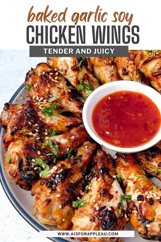 easy soy garlic chicken wings recipe, A plate of soy garlic chicken wings exquisitely baked and garnished with fresh herbs sits beside a bowl of red dipping sauce The text reads soy garlic chicken wings tender and juicy with a website URL subtly placed at the bottom