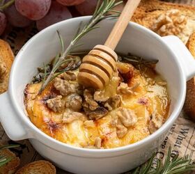 baked brie with honey, Baked Brie with honey and walnuts in a white bowl with thyme and rosemary