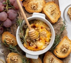 baked brie with honey, Baked brie served with baguettes and grapes on a board