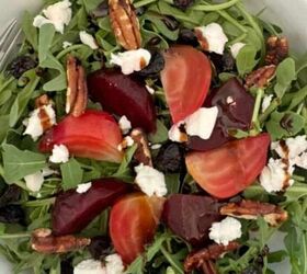 baked brie with honey, Arugula beet and goat cheese salad in a white bowl with a fork stuck in it