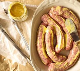 fennel braised sausages, Sausages in an ovenproof dish smeared with mustard