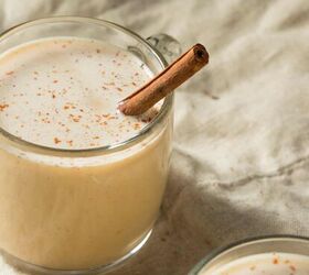 homemade eggnog recipe easy creamy eggnog, image of a mug of Eggnog with a cinnamon stick in it