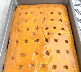 pumpkin poke cake, caramel sauce drizzled over pumpkin cake in a 9 x 13 pan