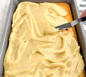 pumpkin poke cake, pumpkin spice pudding spread over pumpkin cake