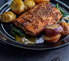 dijon salmon recipe easy baked dijon salmon, Dijon Salmon on a dark plate with potatoes and greens