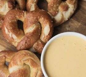 soft sourdough pretzels overnight recipe, Several sourdough pretzels sitting on a wooden cutting board with a bowl of beer cheese dipping sauce