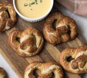 soft sourdough pretzels overnight recipe, Top over picture of five sourdough pretzels sitting on a wooden cutting board A ramekin of beer cheese topped with freshly chopped chives sits next to the pretzels