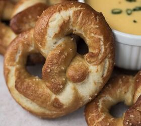 soft sourdough pretzels overnight recipe, Closeup of one sourdough pretzel with beer cheese and other pretzels in the background