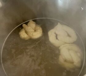 soft sourdough pretzels overnight recipe, Three sourdough pretzels being boiled in the baking soda bath