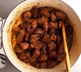 mexican beef stew, The browned and seasoned beef is added back to the Dutch oven with the onions