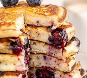 blueberry buttermilk pancakes, Blueberry Buttermilk Pancakes on a Plate with Syrup Slice Taken out