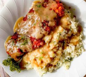 how to make buttermilk fried chicken, A white plate featuring buttermilk fried chicken brown gravy rice and parsley garnish