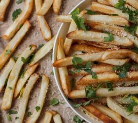 oven baked fries how to make oven baked french fries, Close up image of Oven Baked Fries in a bowl and on brown parchment paper next to it