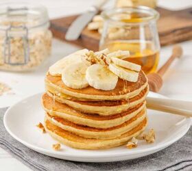 banana oatmeal pancakes healthy banana oatmeal pancakes, Banana Oatmeal Pancakes on a white plate topped with fresh bananas and syrup