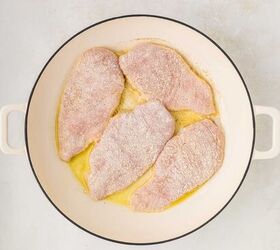 parmesan lemon chicken, dredged chicken in a skillet with olive oil