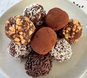 dark chocolate truffles, Dark chocolate truffles stacked on a white plate with some of them covered in cocoa powder nuts or coconut