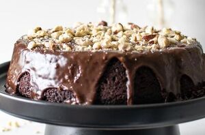 This decadent chocolate hazelnut cake is frosted with chocolate ganache and sprinkled with chopped hazelnuts