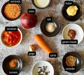 curried lentil carrot soup, Ingredients such as red lentils tomatoes carrots ginger onion and spices for making a soup are placed in small bowls on a tabletop