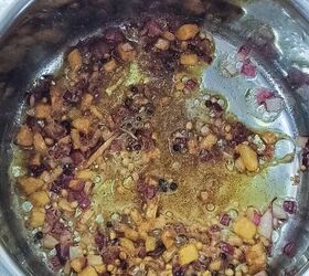 curried lentil carrot soup, Aromatics such as ginger and onions are frying along with some whole spices in a deep saucepan