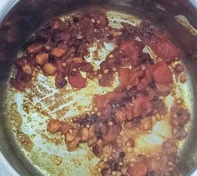 curried lentil carrot soup, Some tomatoes onions and spices are cooked in some oil in a deep soup pot