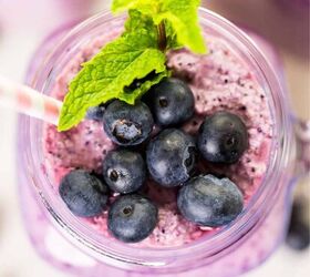 blueberry smoothie recipe easy antioxidant smoothie, overhead image of a blueberry smoothie with mint and blueberry garnish