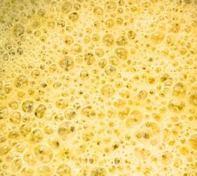 pan seared lamb loin chops with garlic sauce, Garlic and thyme cooking in melted butter in a small saucepan