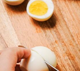 deviled eggs with lifeway farmer cheese, Slicing the hard boiled eggs in half on a wooden board