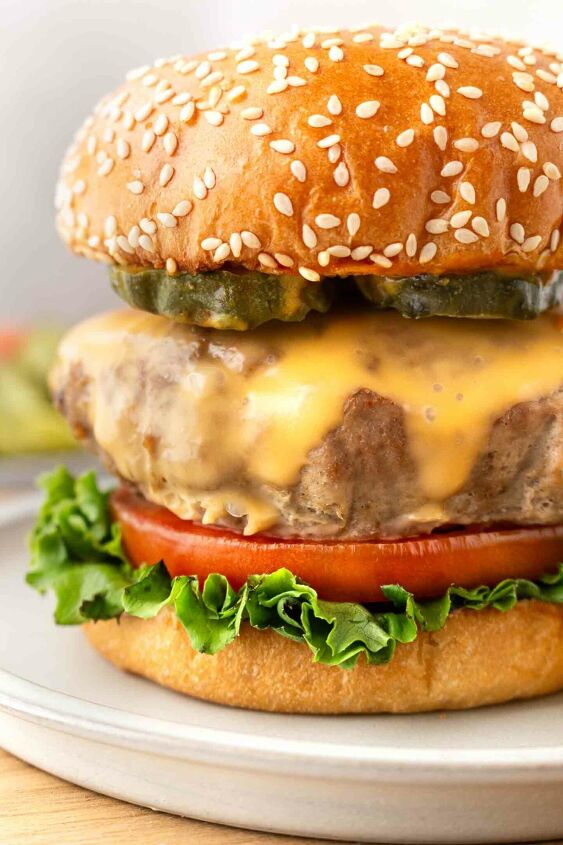 instant pot turkey burgers, closeup of a turkey burger on a bun with lettuce tomato and cheese