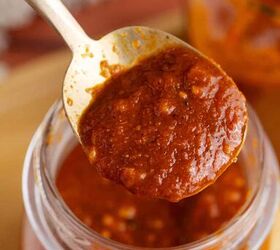 gluten free red enchilada sauce, Gluten Free Red Enchilada Sauce being spooned out of a jar