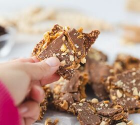 crunchy quinoa chocolate date bark a healthy ish sweet treat, hand holding piece of date bark