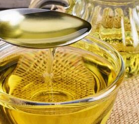 soy sauce braised chicken drumsticks flavorful one pot, Close up of a spoon pouring cooking oil into a glass bowl