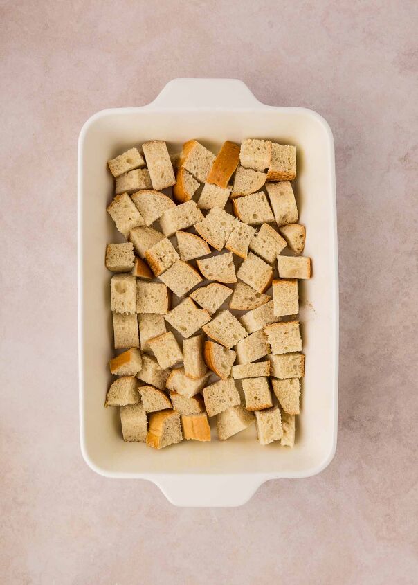 cherry cheesecake french toast casserole, cubed bread on the bottom of casserole dish