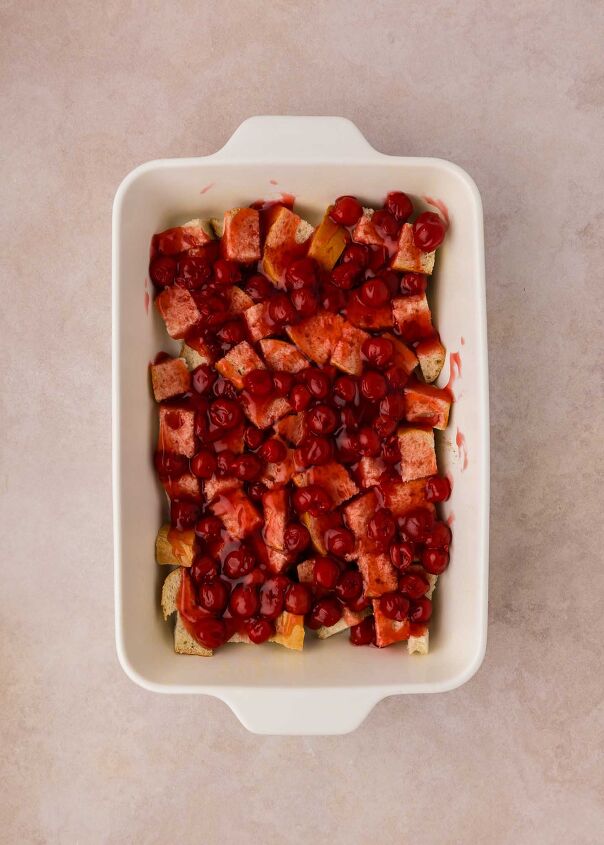 cherry cheesecake french toast casserole, cherry pie filling spread over bread cubes
