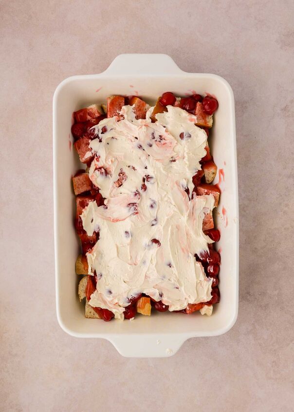 cherry cheesecake french toast casserole, cream cheese mixture spread over the top of pie filling