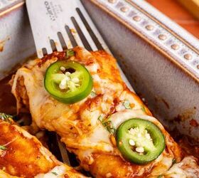 cheesy chicken enchiladas, Enchiladas Close up being scooped out of dish