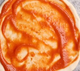 lamb sausage pizza with merguez, Pizza sauce added to shaped pizza dough