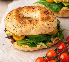 crispy chicken caesar salad, A vibrant veggie hummus bagel sandwich topped with creamy hummus fresh avocado slices crisp cucumber juicy tomatoes and mixed greens served on a toasted everything bagel