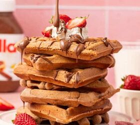 crispy chicken caesar salad, A stack of warm Nutella waffles served with a side of whipped cream fresh strawberries and a rich chocolate hazelnut drizzle creating a decadent and mouthwatering brunch treat