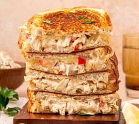 crispy chicken caesar salad, Close up of a crispy chicken salad melt sandwich with golden toasted bread melted cheese and creamy chicken salad filling stacked one above the other
