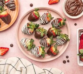 nutella covered strawberries, Nutella covered strawberries in a pink plate with nutella in the side along with fresh strawberries