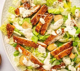 crispy chicken caesar salad, Crispy Chicken caesar salad served in a white oval platter and caesar dressing is drizzled over